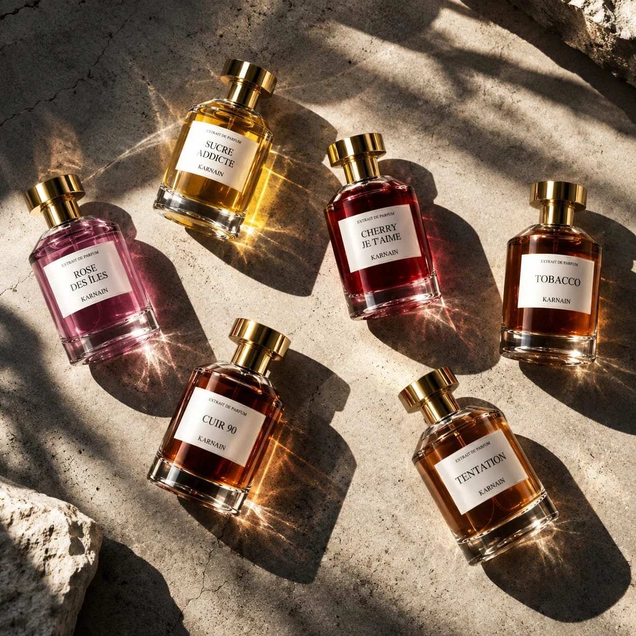 Karnain fragrances in golden light on warm stone